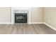 Light-filled living room showcases modern gray floors and a cozy fireplace with elegant marble surround at 7262 Sandpiper Way, Riverdale, GA 30274