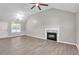 Bright living room showcases gray floors, high ceilings, fireplace, and contemporary lighting at 7262 Sandpiper Way, Riverdale, GA 30274