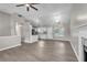 Open living space boasts gray floors, high ceilings, fireplace, and kitchen area, perfect for entertaining at 7262 Sandpiper Way, Riverdale, GA 30274
