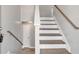 This staircase features hardwood steps, white risers, and wood handrail at 7262 Sandpiper Way, Riverdale, GA 30274