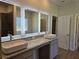 Modern bathroom featuring double sinks, granite countertops and three well-lit mirrors at 1661 Fuma Leaf Way, Mcdonough, GA 30253