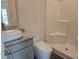Bathroom features a white tile shower and toilet with granite counters and a sink at 1661 Fuma Leaf Way, Mcdonough, GA 30253