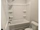 Bathroom featuring a combined shower and bathtub with shelves at 1661 Fuma Leaf Way, Mcdonough, GA 30253
