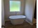 Bathroom with an elegant soaking tub at 1661 Fuma Leaf Way, Mcdonough, GA 30253