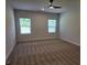 Bedroom with windows and a ceiling fan at 1661 Fuma Leaf Way, Mcdonough, GA 30253