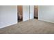 A carpeted bedroom showcases an attached bathroom and closet for convenience at 1661 Fuma Leaf Way, Mcdonough, GA 30253
