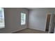 Bedroom features two large windows and beige carpet; door to closet is open at 1661 Fuma Leaf Way, Mcdonough, GA 30253