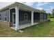 Exterior view of home's patio with white columns and gray brick, siding and trim at 1661 Fuma Leaf Way, Mcdonough, GA 30253