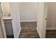 Hallway view showing wood flooring, with a bathroom vanity to the left at 1661 Fuma Leaf Way, Mcdonough, GA 30253
