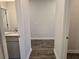 Hallway with view of sink and hardwood floors at 1661 Fuma Leaf Way, Mcdonough, GA 30253