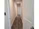 This hallway features hardwood flooring and doors with white trim at 1661 Fuma Leaf Way, Mcdonough, GA 30253