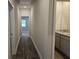 Long hallway featuring wood floors and access to a bathroom and other rooms at 1661 Fuma Leaf Way, Mcdonough, GA 30253