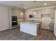 Modern kitchen with stainless steel appliances, ample storage, and granite countertops at 1661 Fuma Leaf Way, Mcdonough, GA 30253