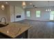 Spacious living room features modern fireplace, wood floors, and plenty of natural light at 1661 Fuma Leaf Way, Mcdonough, GA 30253