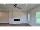 Bright living room with a modern fireplace and large windows for natural light at 1661 Fuma Leaf Way, Mcdonough, GA 30253