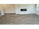Living room with a modern electric fireplace and luxury vinyl flooring at 1661 Fuma Leaf Way, Mcdonough, GA 30253