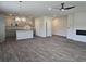 Open concept living area with modern gray cabinets, island, stainless appliances, and fireplace at 1661 Fuma Leaf Way, Mcdonough, GA 30253