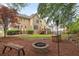 Landscaped backyard offering a fire pit, bench seating, and a wooded area with potential privacy at 4960 Haydens Walk Dr, Johns Creek, GA 30022