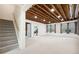 Bright basement with exposed beams, large windows, and staircase leading to upper level at 4960 Haydens Walk Dr, Johns Creek, GA 30022