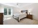 Cozy bedroom with neutral carpet, large window, and traditional furnishings at 4960 Haydens Walk Dr, Johns Creek, GA 30022