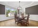 Dining room boasting hardwood floors, modern light fixture, and large windows, creating an inviting space at 4960 Haydens Walk Dr, Johns Creek, GA 30022