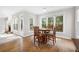 Sunny dining area with hardwood floors, a ceiling fan, and large windows overlooking the backyard at 4960 Haydens Walk Dr, Johns Creek, GA 30022