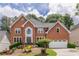Beautiful two-story brick home featuring a landscaped front yard and attached two-car garage at 4960 Haydens Walk Dr, Johns Creek, GA 30022