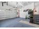 Clean garage featuring blue carpet, white walls, overhead storage, and ample space at 4960 Haydens Walk Dr, Johns Creek, GA 30022