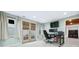 Bright home office features a door to the backyard, carpet, and a work area with multiple monitors at 4960 Haydens Walk Dr, Johns Creek, GA 30022