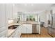 Well-lit kitchen showcasing white cabinets, granite countertops, and stainless steel appliances at 4960 Haydens Walk Dr, Johns Creek, GA 30022