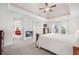 Spacious main bedroom with trey ceilings, fireplace, sitting area, and an abundance of natural light at 4960 Haydens Walk Dr, Johns Creek, GA 30022