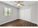 A bright bedroom featuring wood floors, a ceiling fan, and a window with backyard views at 500 Gardenia Ln, Marietta, GA 30068