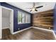 A modern bedroom featuring a striking wood accent wall and stylish ceiling fan at 500 Gardenia Ln, Marietta, GA 30068