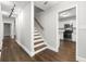 Hallway leading to kitchen with stairs, wood floors, and overhead lighting at 500 Gardenia Ln, Marietta, GA 30068