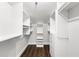 A walk-in closet with custom white shelving, drawers, and dark-stained wood floors at 500 Gardenia Ln, Marietta, GA 30068