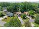 Aerial view of a home surrounded by lush greenery in a residential neighborhood at 850 Long Branch Cir, Sugar Hill, GA 30518