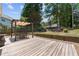 Wooden back deck featuring an overhead pergola and picturesque landscaping at 850 Long Branch Cir, Sugar Hill, GA 30518