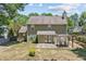 Rear exterior of home with a wooden deck, pergola, and manicured lawn at 850 Long Branch Cir, Sugar Hill, GA 30518