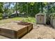 Secluded backyard featuring a stone firepit and storage shed, perfect for outdoor activities at 850 Long Branch Cir, Sugar Hill, GA 30518