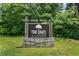 Charming entrance sign for The Oaks at Lanier, set against a backdrop of natural greenery at 850 Long Branch Cir, Sugar Hill, GA 30518