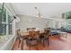 Dining room features a dark wood table set, hardwood floors, crown molding and view to the living room at 850 Long Branch Cir, Sugar Hill, GA 30518