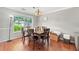 Dining room featuring hardwood floors, a modern light fixture, and a view of backyard at 850 Long Branch Cir, Sugar Hill, GA 30518