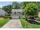 Charming home featuring a well-manicured front yard, a two-car garage, and inviting curb appeal at 850 Long Branch Cir, Sugar Hill, GA 30518