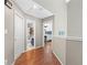 Hallway leading to bedroom and bathroom featuring hardwood floors and neutral paint at 850 Long Branch Cir, Sugar Hill, GA 30518