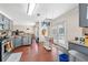Open kitchen with gray cabinetry, wood floors, stainless appliances, and double doors to outdoor deck at 850 Long Branch Cir, Sugar Hill, GA 30518