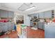 Well-appointed kitchen offers grey cabinets, stainless steel appliances, and hardwood floors at 850 Long Branch Cir, Sugar Hill, GA 30518
