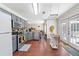 Bright kitchen boasts grey cabinets, stainless steel appliances, hardwood floors, and an open layout at 850 Long Branch Cir, Sugar Hill, GA 30518