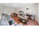 Open living room with gray sofa, fireplace, hardwood floors and neutral paint at 850 Long Branch Cir, Sugar Hill, GA 30518
