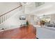 Bright living room boasts hardwood floors and an adjacent dining area providing ample space for entertaining at 850 Long Branch Cir, Sugar Hill, GA 30518