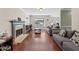 Spacious living room featuring fireplace, hardwood floors and two gray sofas at 850 Long Branch Cir, Sugar Hill, GA 30518
